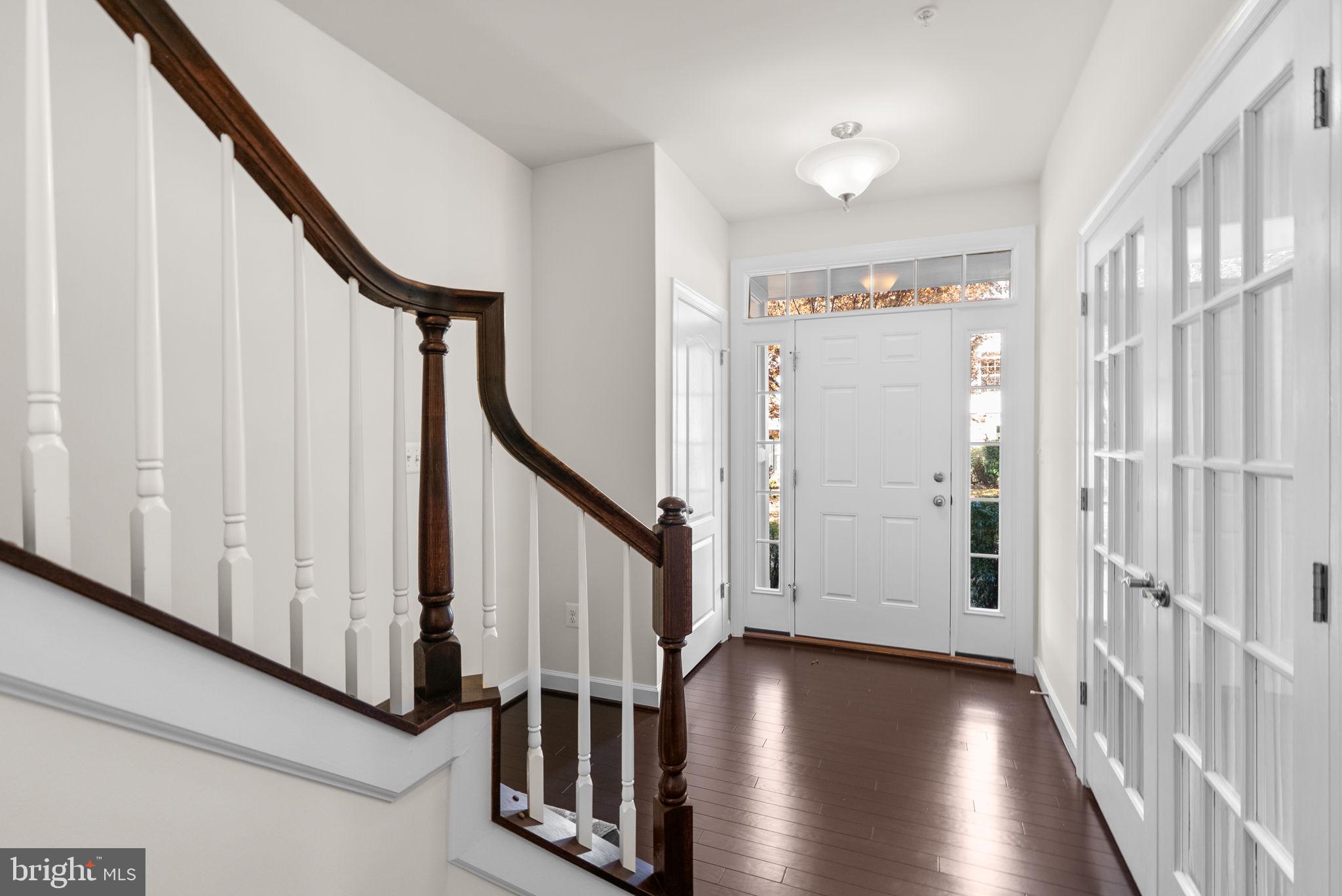 176 Autumn View Drive Gaithersburg, MD 20878 - Photo 4 of 45 a view of a hallway with wooden floor and staircase