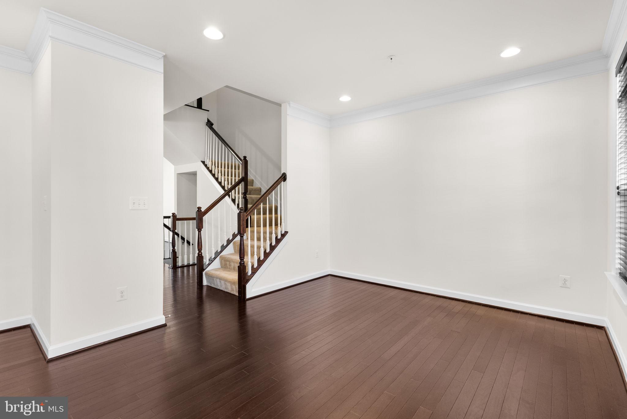 176 Autumn View Drive Gaithersburg, MD 20878 - Photo 6 of 45 a view of an empty room with wooden floor and stairs