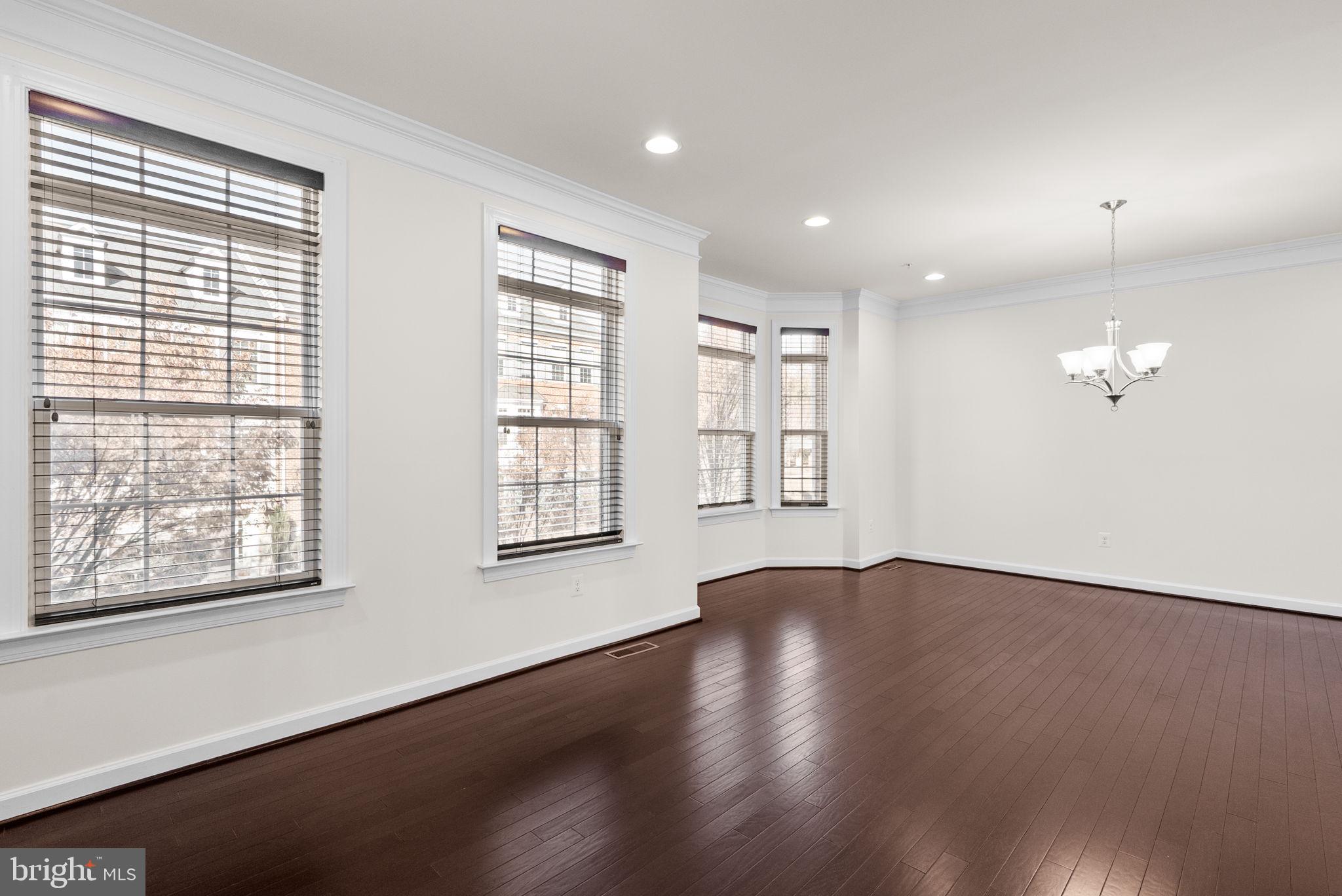 176 Autumn View Drive Gaithersburg, MD 20878 - Photo 8 of 45 an empty room with wooden floor and windows