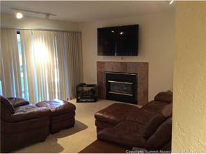 820 Columbine Road, Unit 2 Breckenridge, CO 80424 - Photo 2 of 7 a living room with furniture a fireplace and a flat screen tv