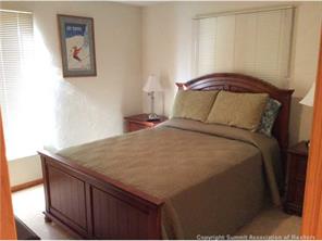 820 Columbine Road, Unit 2 Breckenridge, CO 80424 - Photo 3 of 7 a bedroom with a bed and cupboard