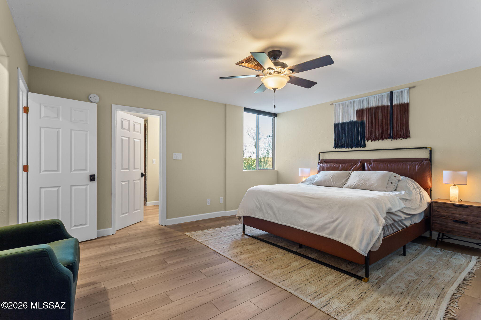 4210 West Mossman Road Tucson, AZ 85746 - Photo 27 of 51 a spacious bedroom with a bed and a chandelier