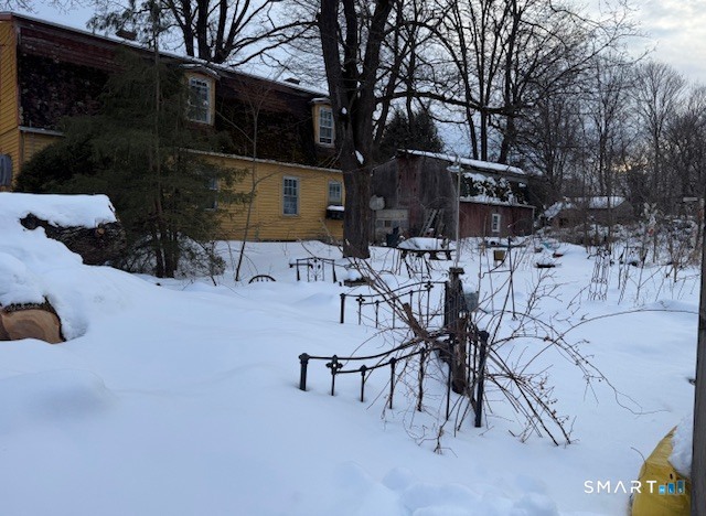 5 Charles Street Windham, CT 06226 - Photo 4 of 6 a view of backyard with table and chairs potted plants and large tree