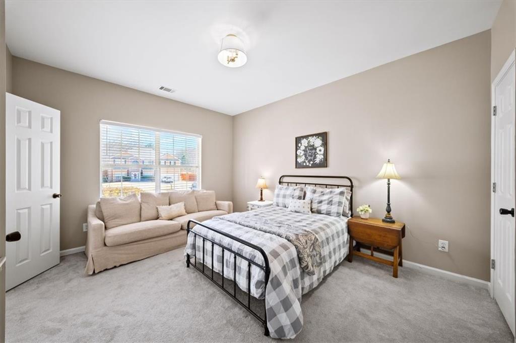 429 Farmwood Way Canton, GA 30115 - Photo 20 of 56 a bedroom with a bed and a lamp