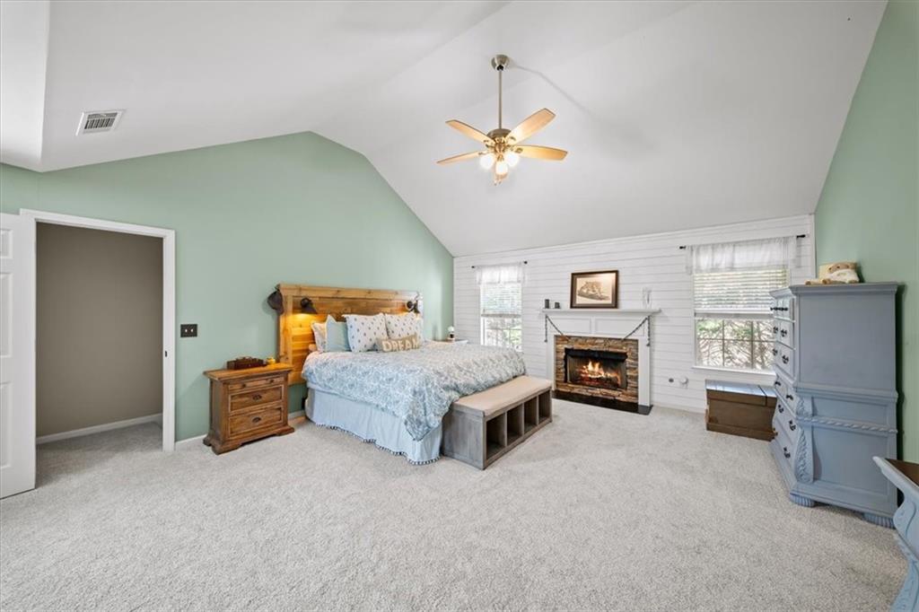 429 Farmwood Way Canton, GA 30115 - Photo 27 of 56 a bedroom with furniture a fireplace and a chandelier