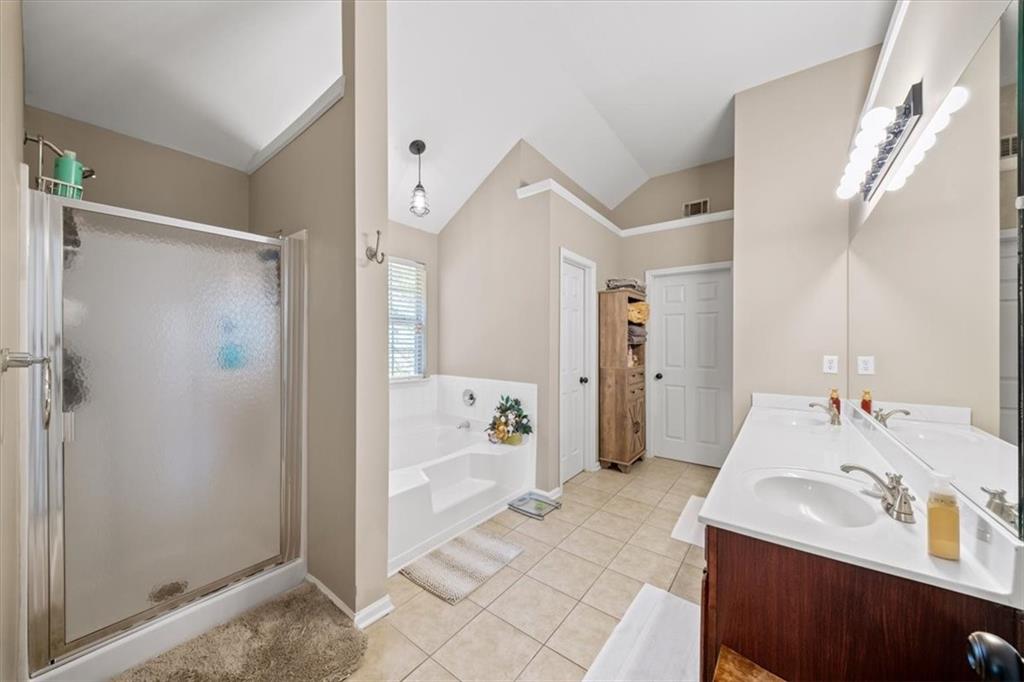 429 Farmwood Way Canton, GA 30115 - Photo 31 of 56 a en suite bathroom with a sink and mirror