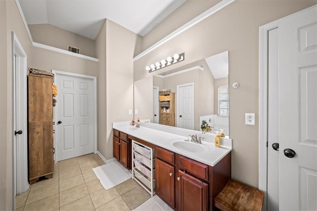 429 Farmwood Way Canton, GA 30115 - Photo 32 of 56 a spacious bathroom with a double vanity sink a mirror and a shower