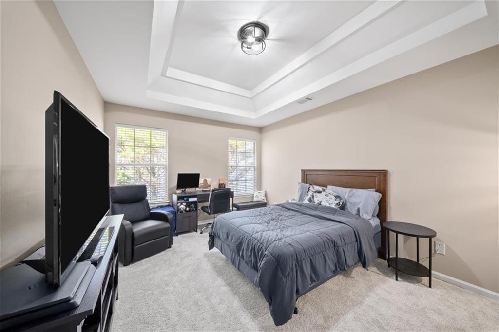 429 Farmwood Way Canton, GA 30115 - Photo 39 of 56 a bedroom with a bed and flat screen tv