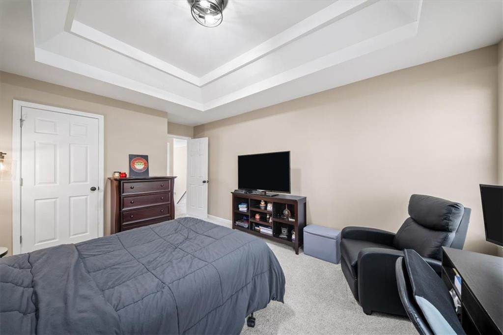 429 Farmwood Way Canton, GA 30115 - Photo 40 of 56 a bedroom with furniture and a flat screen tv