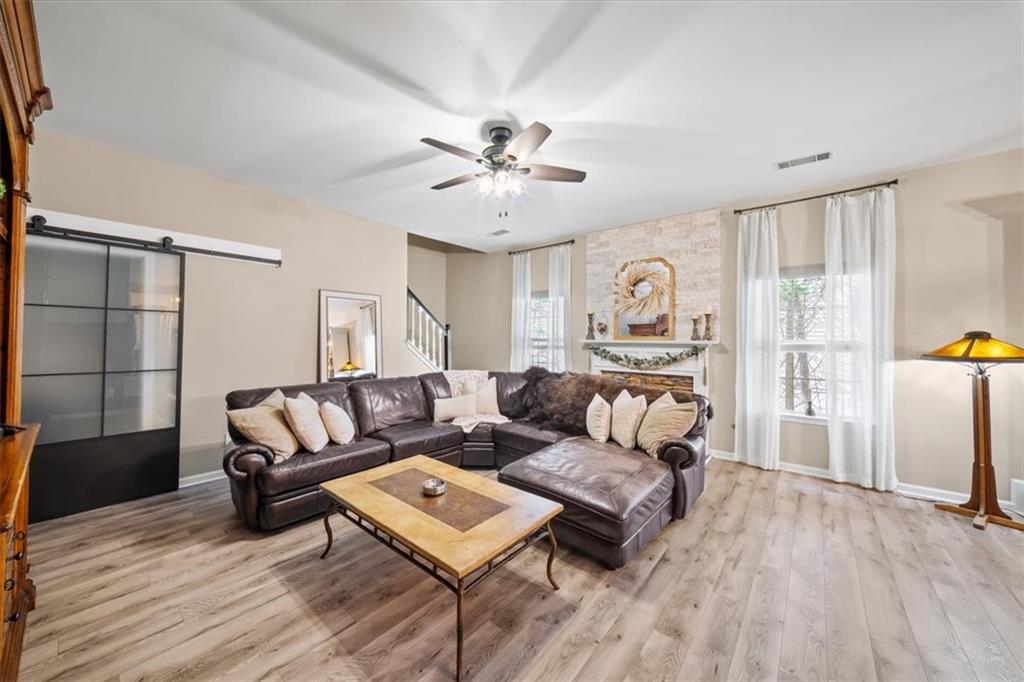 429 Farmwood Way Canton, GA 30115 - Photo 7 of 56 a living room with furniture and a wooden floor
