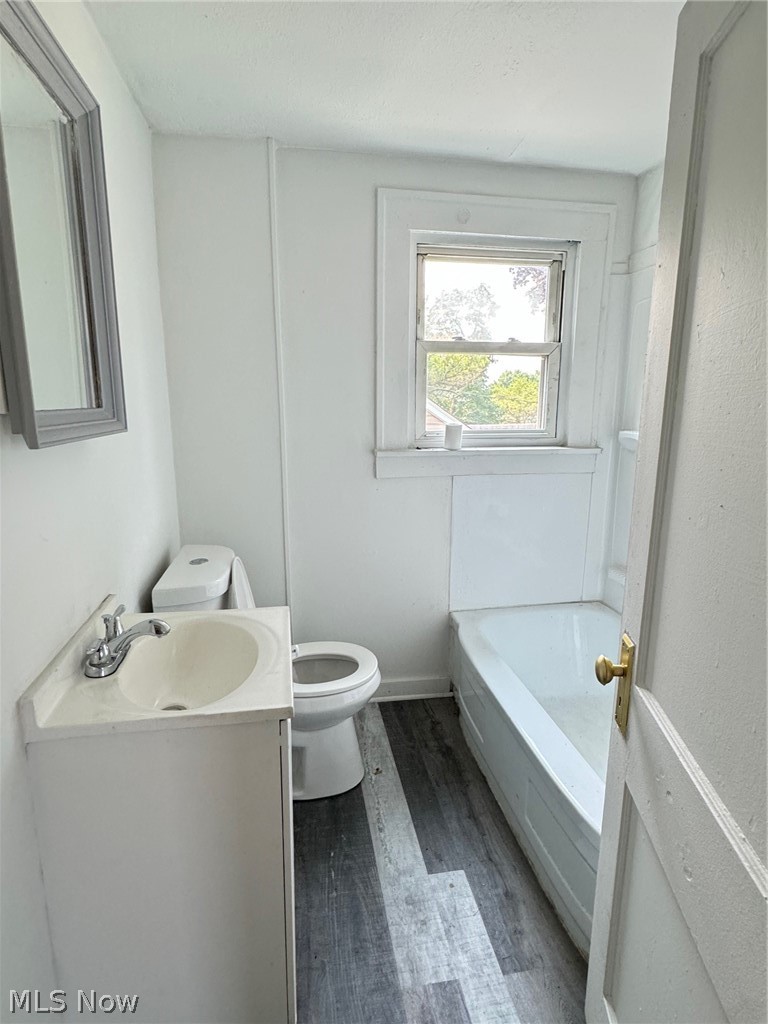 459 Patterson Avenue Akron, OH 44310 - Photo 10 of 24 2nd floor apt. Bathroom with a washtub, hardwood / wood-style flooring, toilet, and vanity