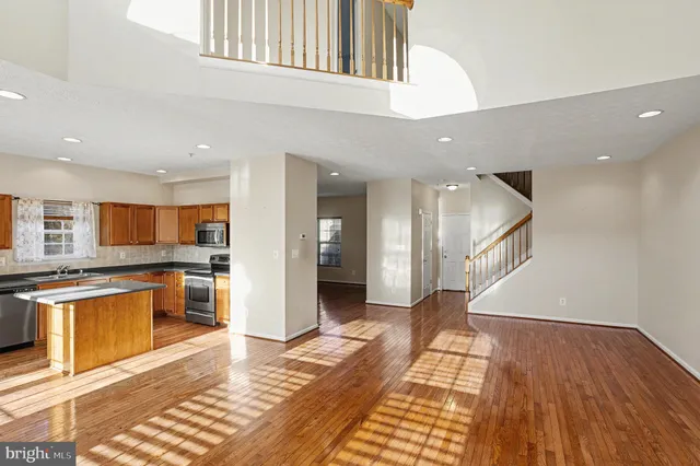 a view of a kitchen with a sink and a refrigerator