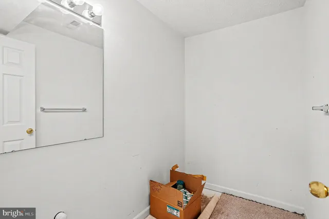 a room with a wooden floor and cabinets