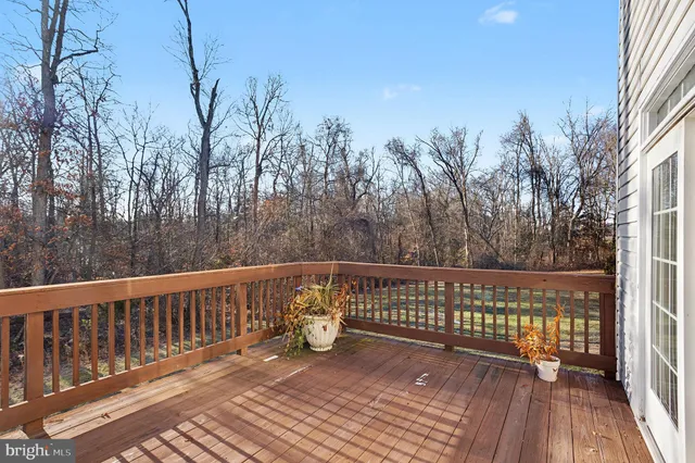 a balcony with wooden floor and fence