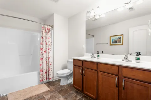 a bedroom with a bed and a chair