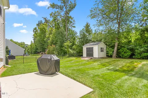 a living room with furniture a flat screen tv and a window