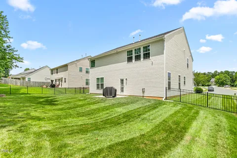 a view of a backyard with a garden and entertaining space