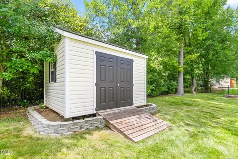 a view of a backyard with plants and a patio