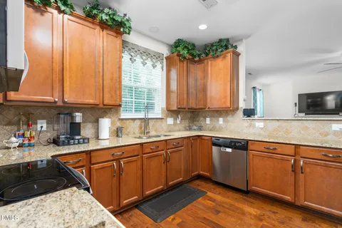 a living room with furniture kitchen view and a potted plant