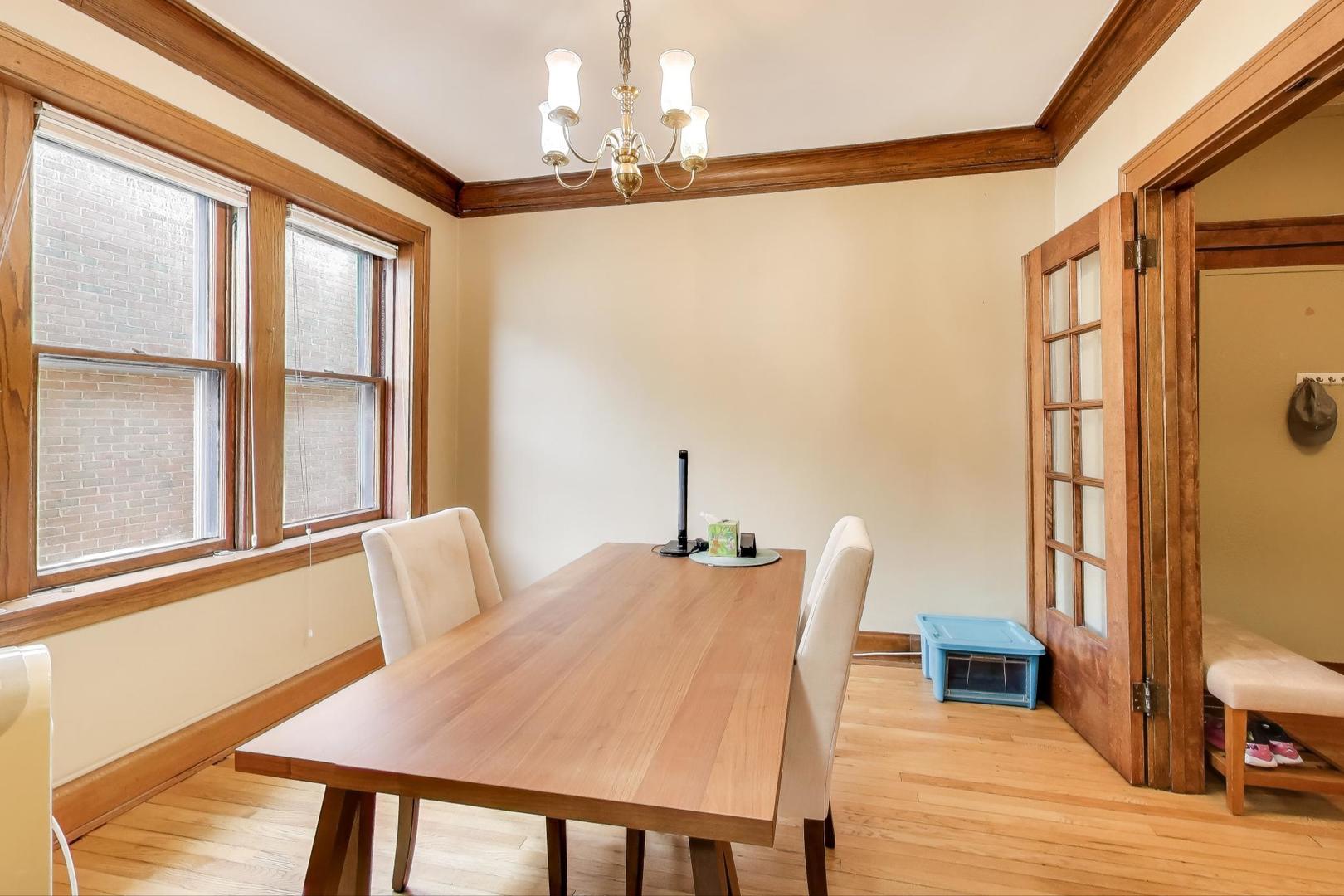 2016 Sherman Avenue, Unit 1E Evanston, IL 60201 - Photo 12 of 25 a view of a dining room with furniture window and wooden floor
