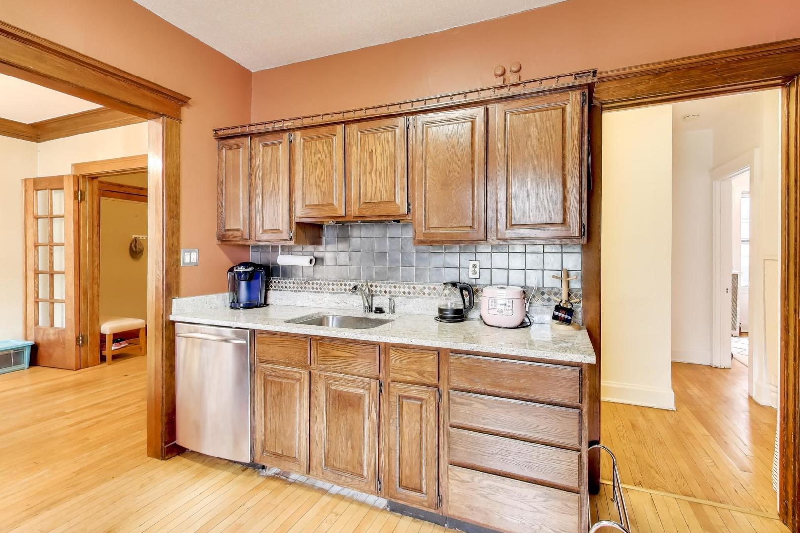 2016 Sherman Avenue, Unit 1E Evanston, IL 60201 - Photo 14 of 25 a kitchen with stainless steel appliances a sink window and cabinets