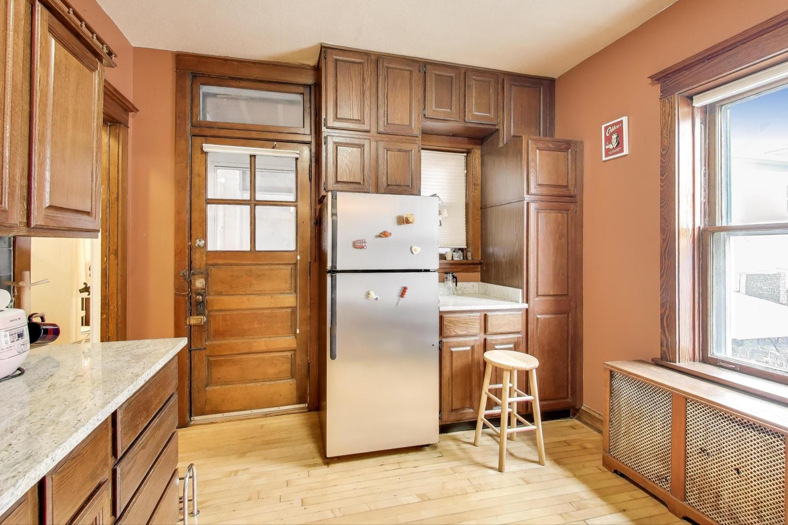 2016 Sherman Avenue, Unit 1E Evanston, IL 60201 - Photo 15 of 25 a kitchen with stainless steel appliances granite countertop a refrigerator and a stove