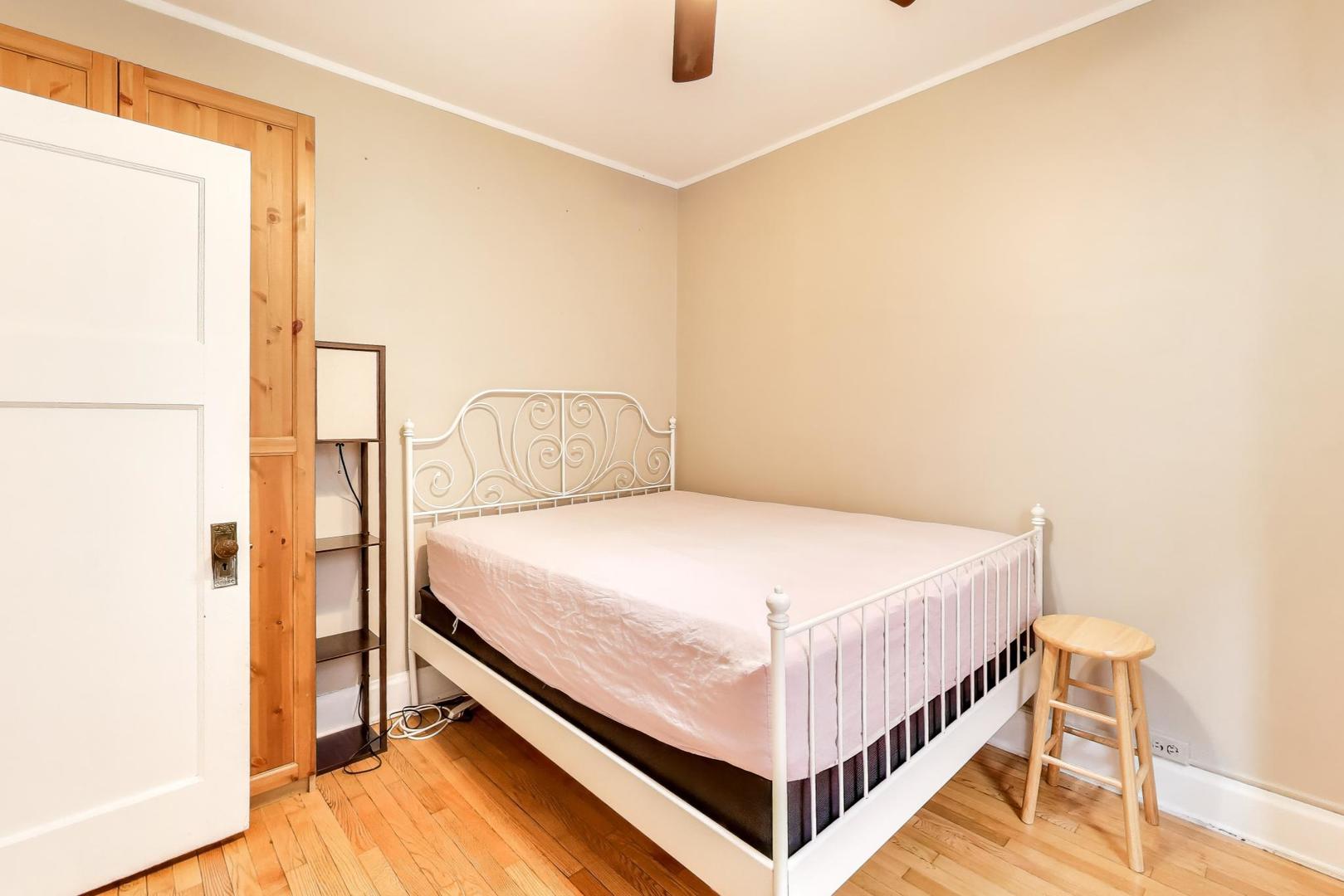 2016 Sherman Avenue, Unit 1E Evanston, IL 60201 - Photo 16 of 25 a bed sitting in a bedroom next to a window