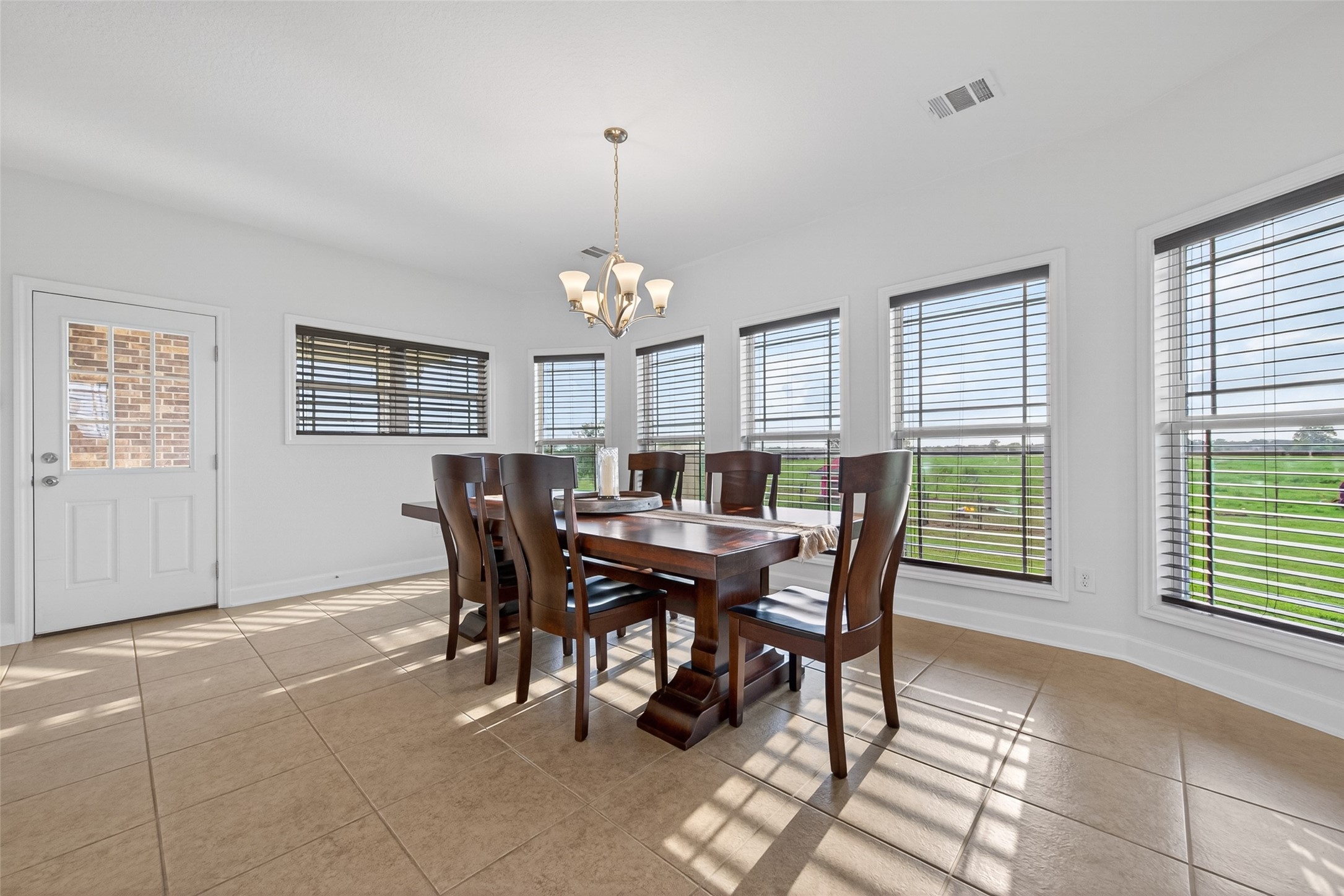 13506 Moody Road Needville, TX 77461 - Photo 16 of 36 Expansive dining area with abundant natural light and acreage views