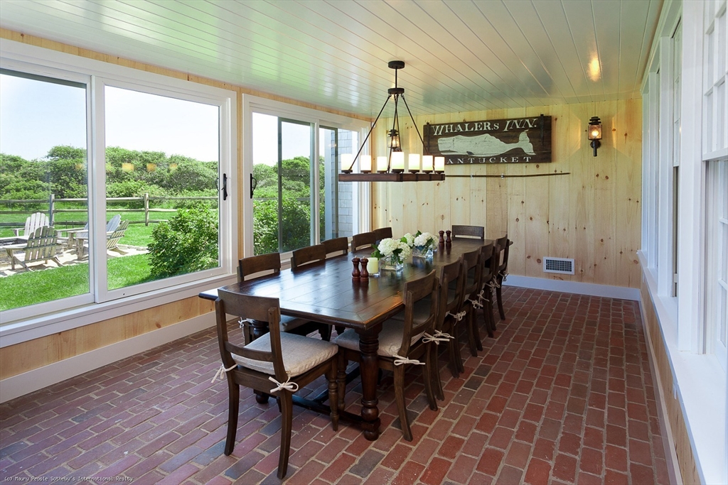 21 Quidnet Road, Unit 1 Nantucket, MA 02554 - Photo 16 of 42 a view of a dining room with furniture window and outside view