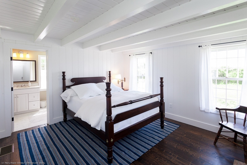 21 Quidnet Road, Unit 1 Nantucket, MA 02554 - Photo 23 of 42 a bedroom with a bed and wooden floor