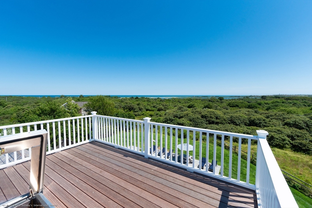21 Quidnet Road, Unit 1 Nantucket, MA 02554 - Photo 35 of 42 a view of balcony with wooden floor and fence