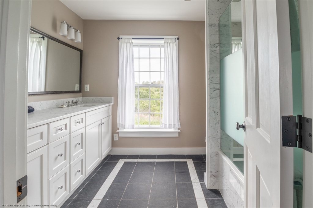 21 Quidnet Road, Unit 1 Nantucket, MA 02554 - Photo 40 of 42 a bathroom with a sink a mirror a vanity and a shower