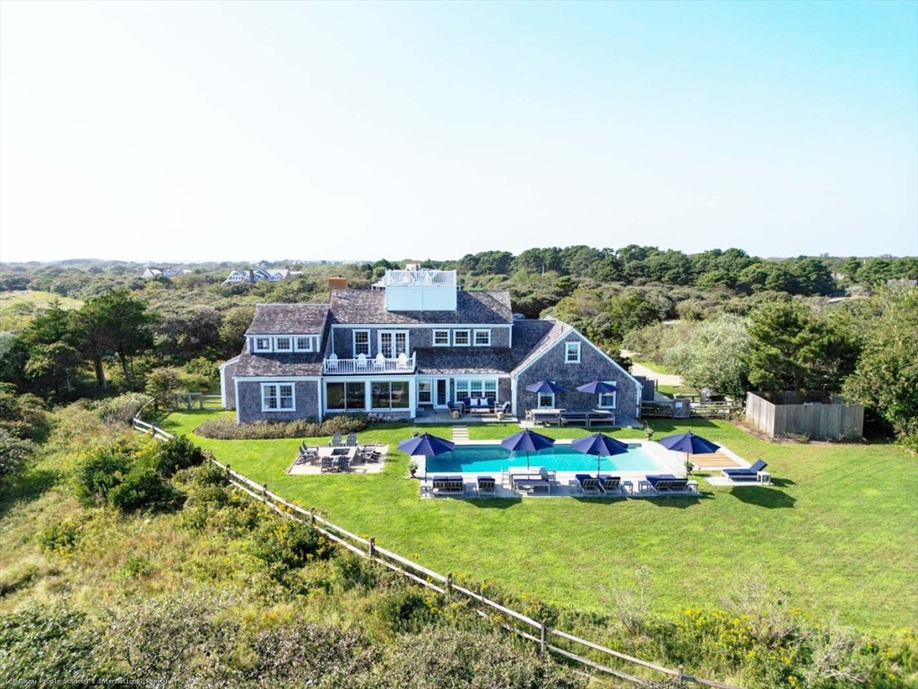 21 Quidnet Road, Unit 1 Nantucket, MA 02554 - Photo 5 of 42 a aerial view of a house with a garden and lake view