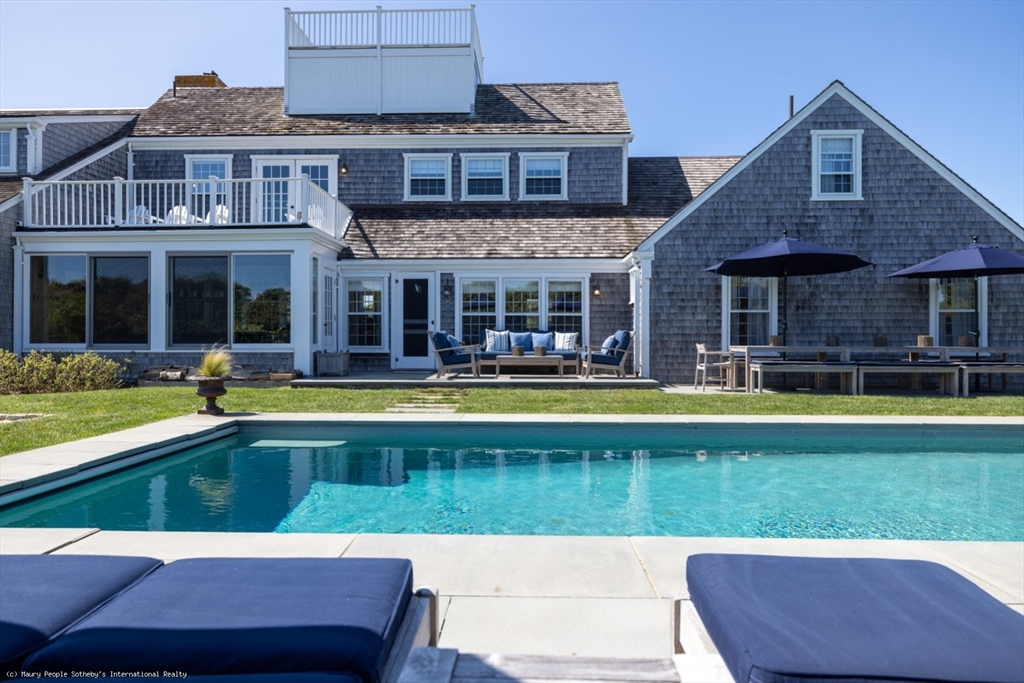 21 Quidnet Road, Unit 1 Nantucket, MA 02554 - Photo 6 of 42 a view of a house with swimming pool and a yard