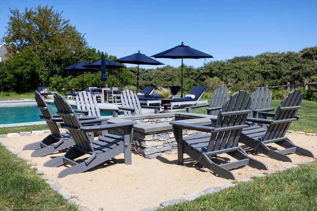 21 Quidnet Road, Unit 1 Nantucket, MA 02554 - Photo 8 of 42 a view of backyard with outdoor seating and trees