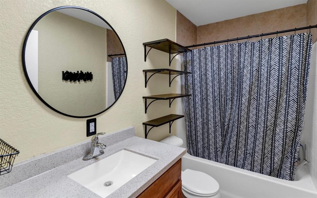 513 Ranch Road Granbury, TX 76049 - Photo 5 of 9 a bathroom with a sink toilet and mirror