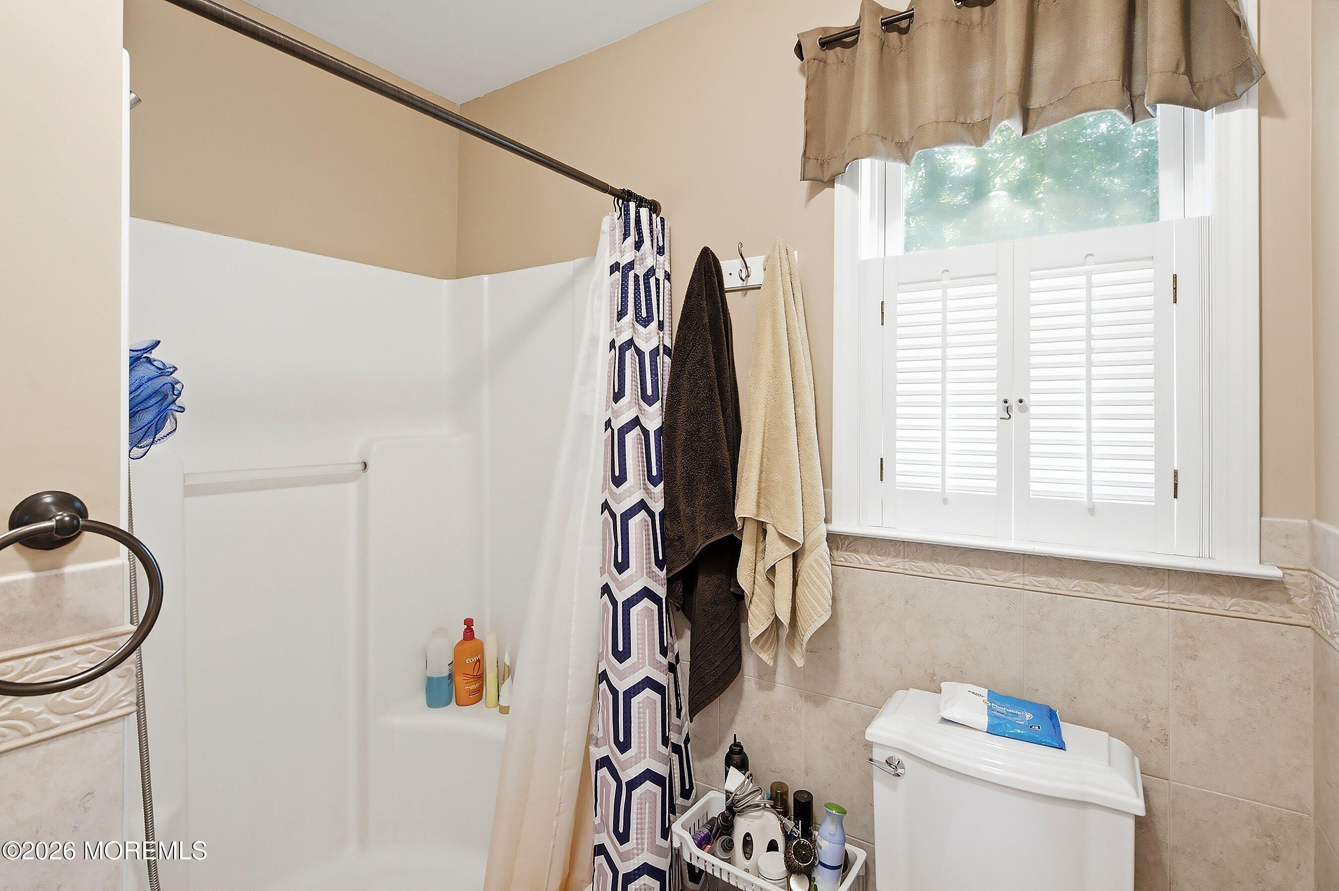935 Bethel Church Road Jackson, NJ 08527 - Photo 16 of 32 a bathroom with a sink a toilet and a shower curtain