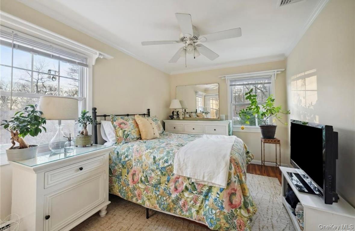 23 North Westbury Road Hampton Bays, NY 11946 - Photo 11 of 19 a bedroom with a bed and a flat screen tv