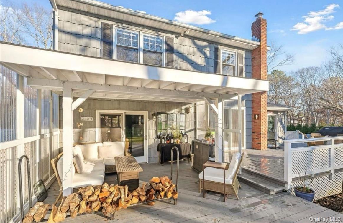 23 North Westbury Road Hampton Bays, NY 11946 - Photo 13 of 19 a view of a porch with furniture and a yard