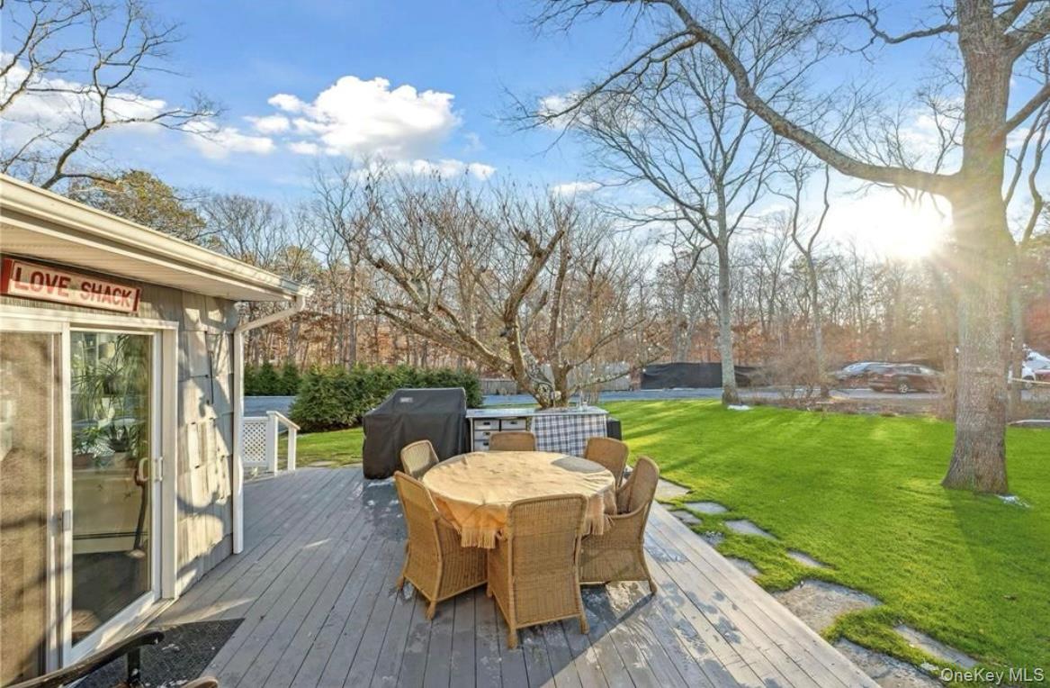 23 North Westbury Road Hampton Bays, NY 11946 - Photo 14 of 19 a view of a deck with a table chairs and a backyard