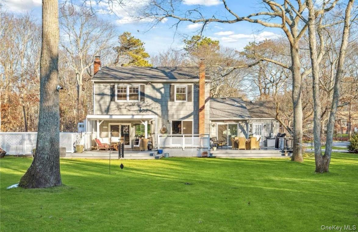23 North Westbury Road Hampton Bays, NY 11946 - Photo 2 of 19 a front view of building with yard and green space