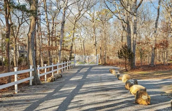 a view of a pathway with a wrought fence