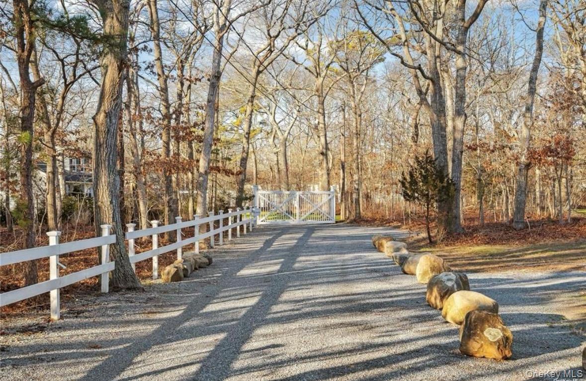 23 North Westbury Road Hampton Bays, NY 11946 - Photo 3 of 19 a view of a pathway with a wrought fence