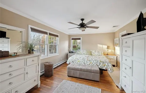 a spacious bedroom with a large bed and a flat screen tv