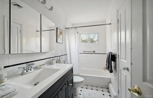 a bathroom with a sink toilet tub and shower