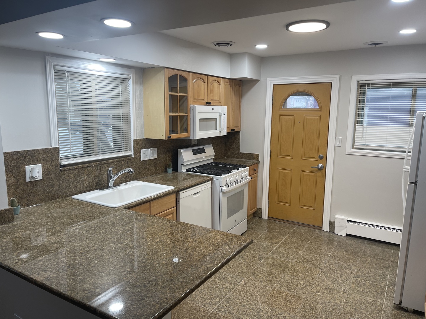 1720 South Cumberland Avenue Park Ridge, IL 60068 - Photo 11 of 26 a kitchen with stainless steel appliances granite countertop a sink stove and refrigerator