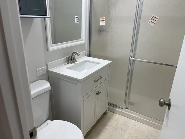 a bathroom with a glass door shower