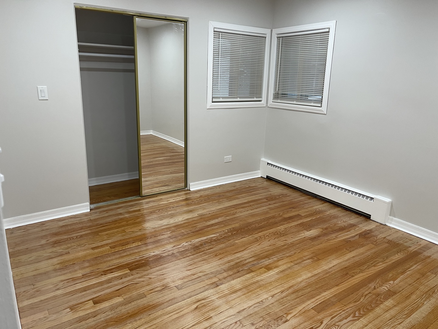 1720 South Cumberland Avenue Park Ridge, IL 60068 - Photo 18 of 26 an empty room with wooden floor and windows