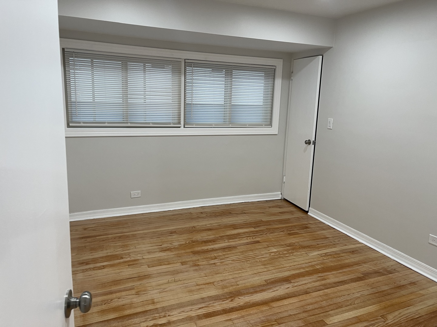 1720 South Cumberland Avenue Park Ridge, IL 60068 - Photo 19 of 26 an empty room with wooden floor and windows