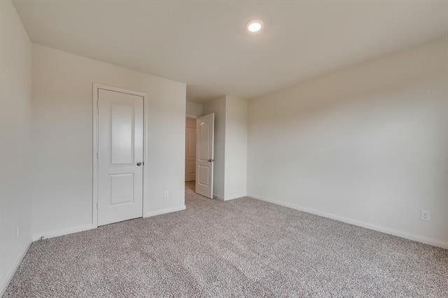 13609 Mineral Road Ponder, TX 76259 - Photo 14 of 21 Spacious room featuring neutral paint, gray carpeting, a single recessed light fixture, and white two-panel doors